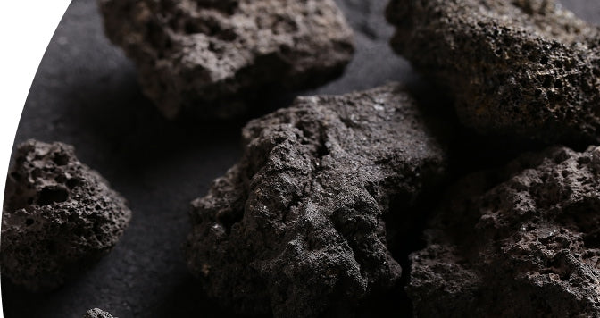 Close-up of dark volcanic rocks on a black background